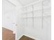 Walk-in closet with wire shelving and wood-look flooring at 2434 Mill Run Blvd, Kissimmee, FL 34744