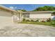 Single-story home featuring a two-car garage and landscaped yard at 2434 Mill Run Blvd, Kissimmee, FL 34744