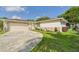 Inviting home with a two-car garage and a curved driveway at 2434 Mill Run Blvd, Kissimmee, FL 34744