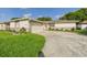 Single-story home featuring a two-car garage and landscaped yard at 2434 Mill Run Blvd, Kissimmee, FL 34744