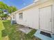 Exterior view of the house with a side entrance and a utility area at 2434 Mill Run Blvd, Kissimmee, FL 34744