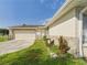 Single-story home featuring a two-car garage and landscaped yard at 2434 Mill Run Blvd, Kissimmee, FL 34744