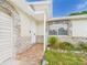 Charming front entrance with stone accents, tiled porch, and vibrant landscaping for enhanced curb appeal at 2434 Mill Run Blvd, Kissimmee, FL 34744