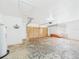 Bright garage with overhead storage, and a wooden garage door at 2434 Mill Run Blvd, Kissimmee, FL 34744