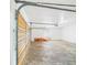 Bright garage with wooden door and overhead storage at 2434 Mill Run Blvd, Kissimmee, FL 34744