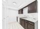 Bright kitchen featuring stainless steel sink, marble-like countertop, and dark brown cabinets at 2434 Mill Run Blvd, Kissimmee, FL 34744