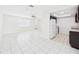 Open-concept design with kitchen view including white appliances, dark cabinets, and tile flooring at 2434 Mill Run Blvd, Kissimmee, FL 34744