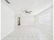 Open living room with tile flooring, a ceiling fan, and a large window for natural light at 2434 Mill Run Blvd, Kissimmee, FL 34744