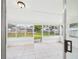 Enclosed sunroom featuring white tiled floor and multiple large windows overlooking the backyard at 2434 Mill Run Blvd, Kissimmee, FL 34744
