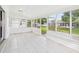 Enclosed sunroom boasting white tiled floor and multiple large windows for ample natural light at 2434 Mill Run Blvd, Kissimmee, FL 34744