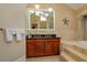 Bathroom featuring double sinks and relaxing soaking tub at 2506 Partridge Dr, Winter Haven, FL 33884