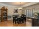 Elegant dining room featuring a dark wood table, ornate chandelier, and large window for natural light at 2506 Partridge Dr, Winter Haven, FL 33884
