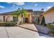 Home's exterior features a brick walkway leading to the front door, complemented by lush plantings at 2506 Partridge Dr, Winter Haven, FL 33884