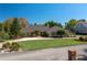 Charming single-story home boasts a circular driveway, mature landscaping, and neutral color palette at 2506 Partridge Dr, Winter Haven, FL 33884