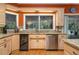 Kitchen area with stainless steel dishwasher, wine cooler, and granite countertops at 2506 Partridge Dr, Winter Haven, FL 33884