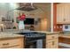 Kitchen island with granite countertops, cooktop, and modern vent hood at 2506 Partridge Dr, Winter Haven, FL 33884