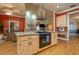 Kitchen island featuring a cooktop, granite countertops, and ample storage at 2506 Partridge Dr, Winter Haven, FL 33884