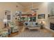 Open-concept living room featuring a fireplace, hardwood floors, and open kitchen at 2506 Partridge Dr, Winter Haven, FL 33884