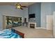 Large main bedroom with a fireplace, TV, and sliding glass doors leading to the outdoor pool area at 2506 Partridge Dr, Winter Haven, FL 33884