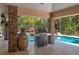 Covered outdoor kitchen with grill and decorative pineapple near the pool at 2506 Partridge Dr, Winter Haven, FL 33884