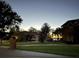 Serene street view showcasing lovely homes with manicured lawns and a distant sunset over the water at 2506 Partridge Dr, Winter Haven, FL 33884