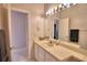 Bright bathroom showcasing white cabinets, a large mirror, and neutral wall paint at 26 Casarena Ct, Winter Haven, FL 33881