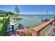 A view of a dock stretching out into a tranquil lake, complete with benches and an American flag at 26 Casarena Ct, Winter Haven, FL 33881