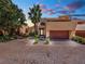 Unique two-story home with a brick driveway, stucco exterior, and balcony overlooking the sunset at 26 Casarena Ct, Winter Haven, FL 33881