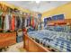 Bedroom featuring a wooden bed frame, full closet and a view of the closet storage space at 2606 Tall Palm Ave, Lake Wales, FL 33898