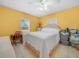 Bright bedroom with tile floors, a large window, and a queen-size bed at 2606 Tall Palm Ave, Lake Wales, FL 33898