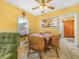 Cozy dining area with wicker chairs, ceiling fan, and view into kitchen at 2606 Tall Palm Ave, Lake Wales, FL 33898