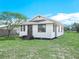 Charming single-story home with a welcoming porch, green lawn and mature trees at 2606 Tall Palm Ave, Lake Wales, FL 33898