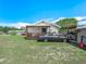 Charming single-story home with a welcoming porch and a lush green lawn at 2606 Tall Palm Ave, Lake Wales, FL 33898