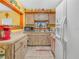 Well-lit kitchen with wood cabinets, white appliances, and a window view at 2606 Tall Palm Ave, Lake Wales, FL 33898