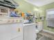 Functional laundry room with washer, dryer, and ample shelving at 2606 Tall Palm Ave, Lake Wales, FL 33898