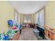 Cozy living room with carpet, wood-panel wainscoting, and natural light from the window at 2606 Tall Palm Ave, Lake Wales, FL 33898