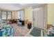 Cozy living room with carpet, wood-panel wainscoting, and natural light from the window at 2606 Tall Palm Ave, Lake Wales, FL 33898