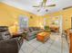 Spacious living room with tile flooring, ceiling fan, and views into the dining and kitchen areas at 2606 Tall Palm Ave, Lake Wales, FL 33898