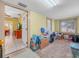 Cozy living room with carpet, wood-panel wainscoting, and natural light from the window at 2606 Tall Palm Ave, Lake Wales, FL 33898