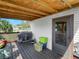Cozy porch with wood ceiling, open-air access, with a grill and outdoor storage at 2606 Tall Palm Ave, Lake Wales, FL 33898