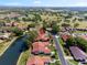 An aerial view of a neighborhood near a golf course with lush greenery and community pond at 2637 Sunburst Ct, Lake Wales, FL 33898