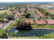 Scenic aerial view of a neighborhood featuring well-maintained homes and a serene pond at 2637 Sunburst Ct, Lake Wales, FL 33898