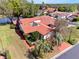 An aerial view of the home shows well-manicured landscaping and a tile roof near a tranquil pond at 2637 Sunburst Ct, Lake Wales, FL 33898