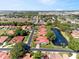 Beautiful aerial view of a neighborhood featuring well-maintained homes and a serene pond at 2637 Sunburst Ct, Lake Wales, FL 33898