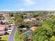 Beautiful aerial view of neighborhood featuring private pool, well-maintained homes, and serene pond at 2637 Sunburst Ct, Lake Wales, FL 33898