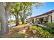 Relaxing backyard with a patio overlooking a tranquil lake, complemented by lush greenery and mature trees at 2637 Sunburst Ct, Lake Wales, FL 33898