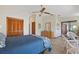 Well-lit bedroom featuring tiled floors, a ceiling fan, and access to an enclosed patio at 2637 Sunburst Ct, Lake Wales, FL 33898