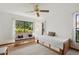 Bright bedroom featuring a bed with built-in drawers and a cozy rattan couch at 2637 Sunburst Ct, Lake Wales, FL 33898