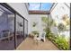 Private courtyard with gravel flooring, tropical foliage, and ample sunlight offers a relaxing outdoor living space at 2637 Sunburst Ct, Lake Wales, FL 33898