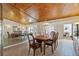 Formal dining room featuring a wooden table, chandelier, wood ceiling, and a mirrored wall that enhances the space at 2637 Sunburst Ct, Lake Wales, FL 33898